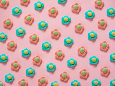 Pink and blue flower jelly candies pattern on pink backgroundの写真素材