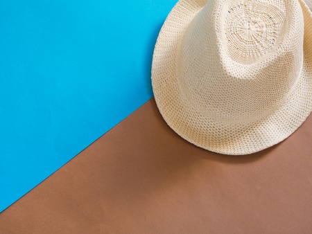 Straw hat on blue and brown background with copy spaceの写真素材