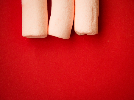 Marshmallows on red background with copy spaceの写真素材