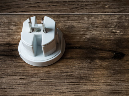 Male american plug on wood background