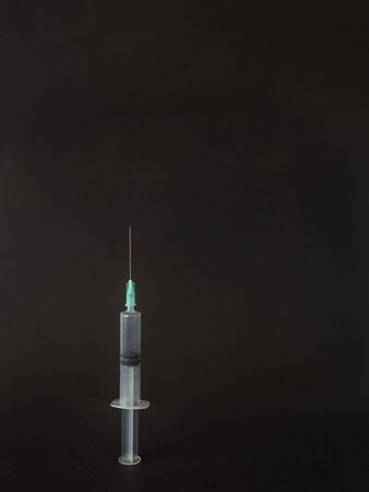 Syringe on black background with copy spaceの写真素材