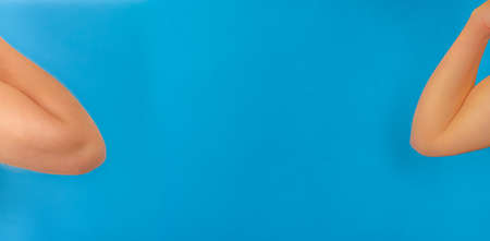 Elbows, coronavirus handshake concept with copy space on blue backgroundの写真素材