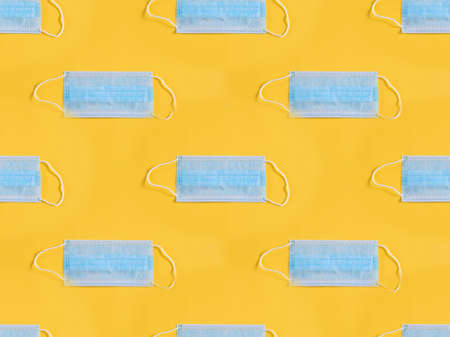 Surgical mask on yellow backgroundの写真素材