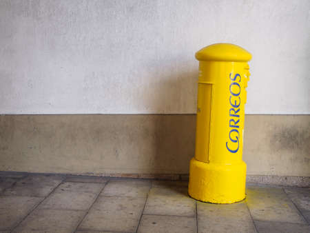 A Coruna, Spain - October 1, 2016 - Yellow mailbox of Correos in the street with copy spaceのeditorial素材