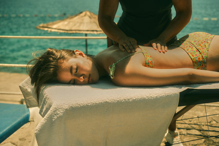 Massage therapist on the beach preparing to massageの写真素材