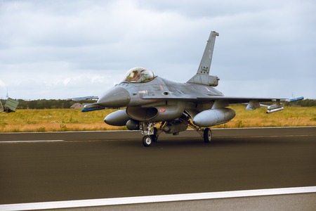 Schleswig - Jagel, Germany - June 19, 2014: Netherlands - Air Force General Dynamics F-16A Fighting Falcon J-643 is taxiing on strip of airbase Schleswigのeditorial素材