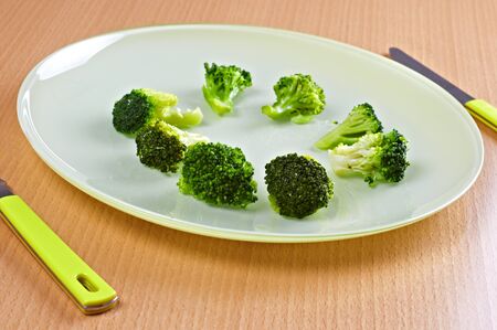 Green broccoli in green dish の写真素材