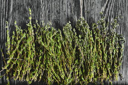 Fresh green thyme on dark wood backroundの写真素材