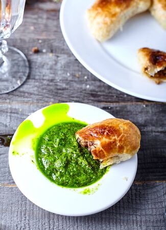 Empanadas on white plate - argentine roasted meat pies on wood backgroundの写真素材