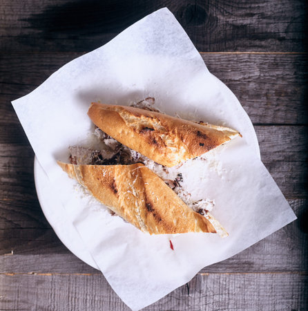 Baguet sandwich with beef and mayonnaise on wood backgroundの写真素材