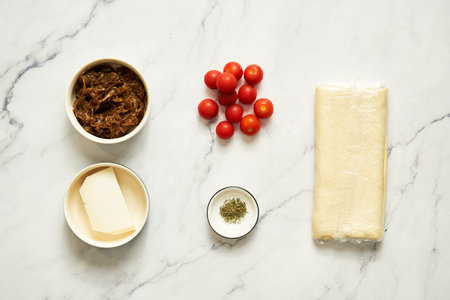 Caramelised onion tart ingredients goat cheese, caramelised onions, thyme and cherry tomatoes, puff...