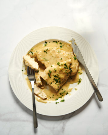 Chicken breasts in mustard sauce on white plateの写真素材