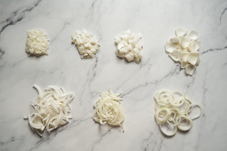 Different cuts of onions. Photo show different onion cuts from small to large dice, rings, chunks and half moon slice plus julienneの写真素材