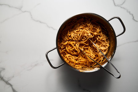 Pot of mexican pasta. Pasta with tomato sauce with chilli puree, feta and cream cheese. Spaghetti macaroni boiled al dente and mixed with sauceの写真素材