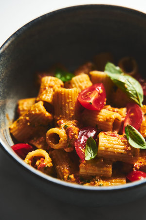 Sicilian Pesto Pasta. Pasta alla trapanese. Rigatoni pasta with pesto from cherry tomatoes and...