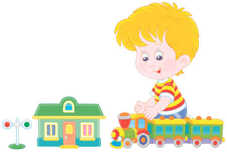 Happy little boy playing with a toy railway train and a station in his playroom, vector cartoon illustration on a white backgroundのイラスト素材