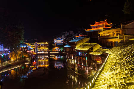 View during twilight over Tuojiang River Tuo Jiang River in Fenghuang Old City Phoenix Ancient Town, Hunan Province, Chinaのeditorial素材