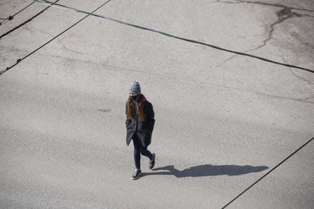 lonely masked girl walking the street during quarantineのeditorial素材