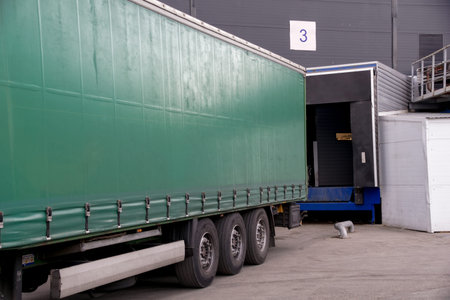 unloading a truck near the gates of a warehouse or shopping center