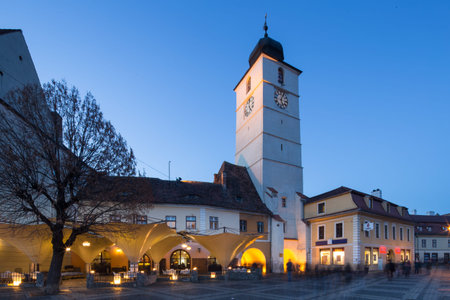 Downtown and main square at dusk with lights on in Sibiu, Romaniaの写真素材
