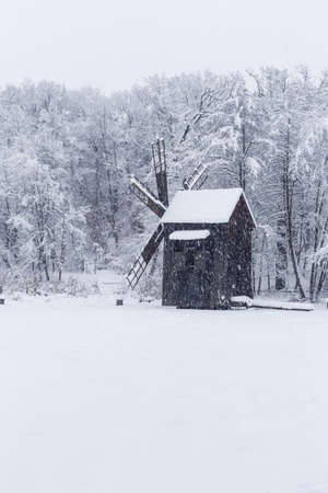 Windmill in Village Museum during snowy winterの写真素材