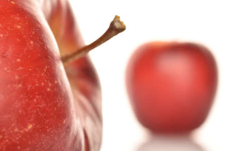 Two red organic apples, close-up, on a white background.の写真素材