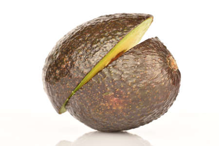 Two halves of a dark green, ripe fragrant tasty avocado on a white background.の写真素材