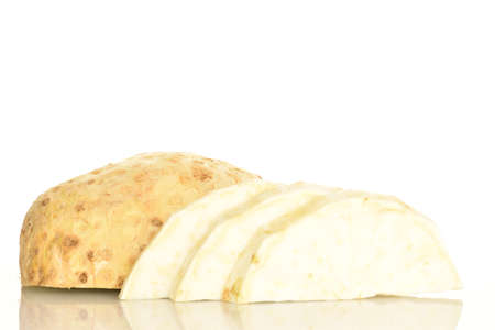 One half and sliced slices of ripe spicy juicy organic celery root, close-up, on a white background.の写真素材