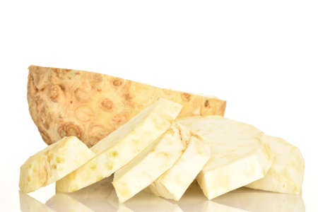 One half and sliced slices of ripe spicy juicy organic celery root, close-up, on a white background.の写真素材