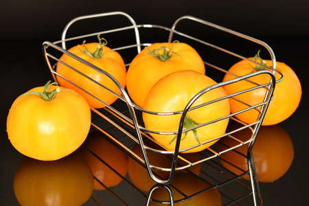 Fresh juicy yellow tomatoes, close-up, on a black background.の写真素材