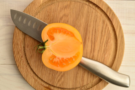 Ripe juicy, yellow tomatoes, close-up, on a painted white table.の写真素材