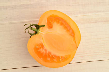 Ripe juicy, yellow tomatoes. Macro on a painted white table.の写真素材