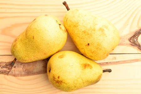 Ripe juicy, organic pears, close-up, on a wooden table.の写真素材