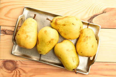 Ripe juicy, organic pears, close-up, on a wooden table.の写真素材