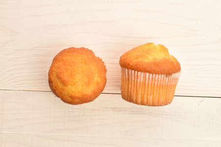 Tasty sweet muffins, close-up, on a painted wooden table.の写真素材