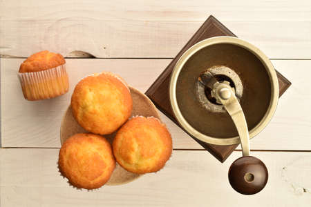 Tasty sweet muffins, close-up, on a painted wooden table.の写真素材