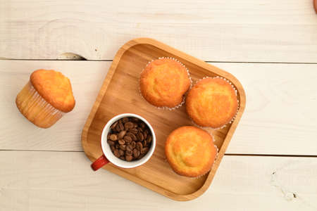 Sweet tasty muffins, close-up, on a painted wooden tableの写真素材