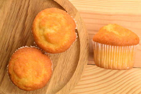 Sweet tasty muffins, close-up, on a wooden tableの写真素材