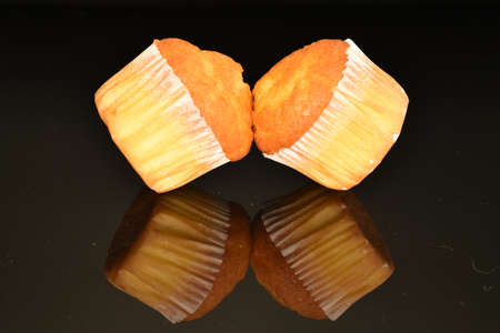 Fresh tasty muffins, close-up, on a black background.の写真素材