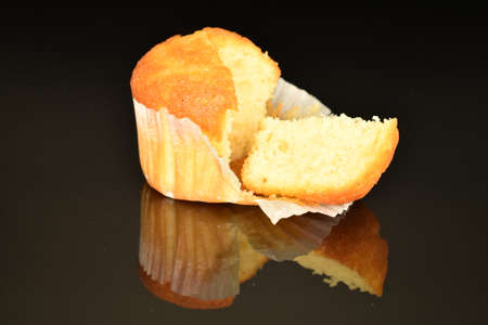 Fresh tasty muffins, close-up, on a black background.の写真素材