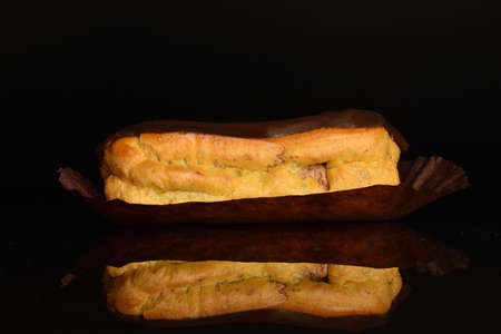 Sweet, mouth-watering chocolate eclairs, close-up, on a black background.の写真素材