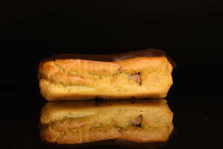 Sweet, mouth-watering chocolate eclairs, close-up, on a black background.の写真素材