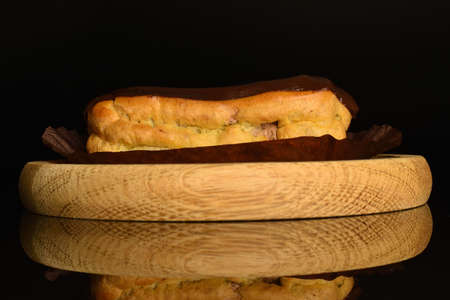 Sweet, mouth-watering chocolate eclairs, close-up, on a black background.の写真素材