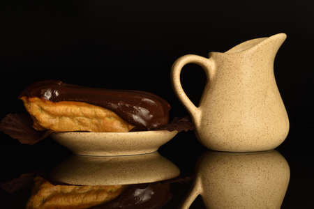 Sweet, mouth-watering chocolate eclairs, close-up, on a black background.の写真素材