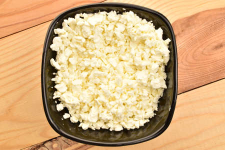Fresh tasty, nutritious cottage cheese, close-up, on a wooden table.の写真素材