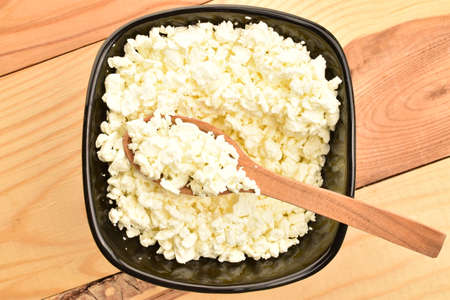 Fresh tasty, nutritious cottage cheese, close-up, on a wooden table.の写真素材