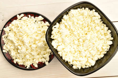 Fresh tasty, nutritious cottage cheese, close-up, on a painted wooden table.の写真素材