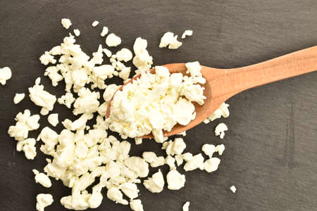 Fresh tasty, nutritious cottage cheese, close-up, on a serving plate of slate.の写真素材