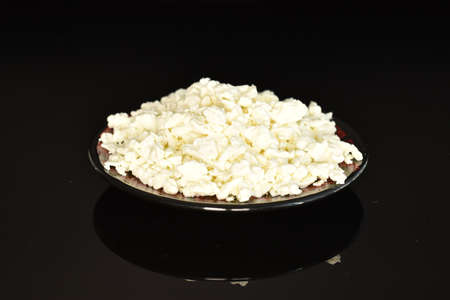 Fresh tasty, nutritious cottage cheese, close-up, on a black background.の写真素材