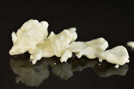 Fresh tasty, nutritious cottage cheese, close-up, on a black background.の写真素材